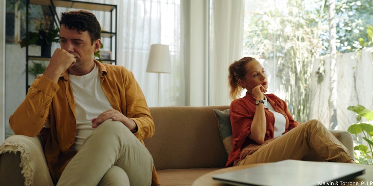 Couple experiencing signs you should get a divorce sitting separately